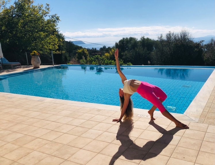 Yoga pose by the pool with sea views
